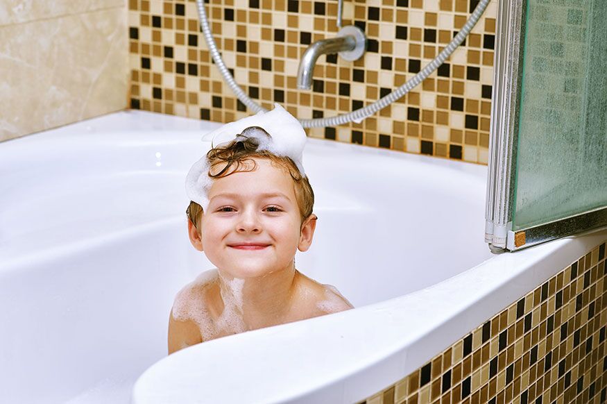 Smiling kid in bathtub