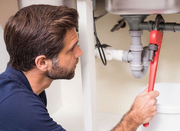 one of our highly trained technicians working on plumbing in Fremont job